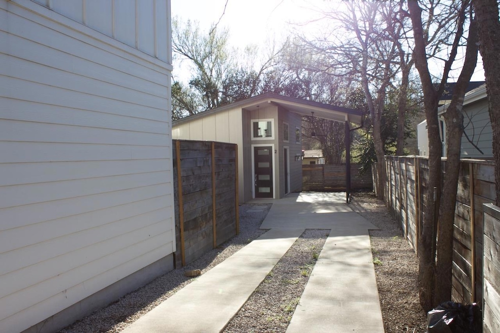 View of property exterior with an outdoor structu