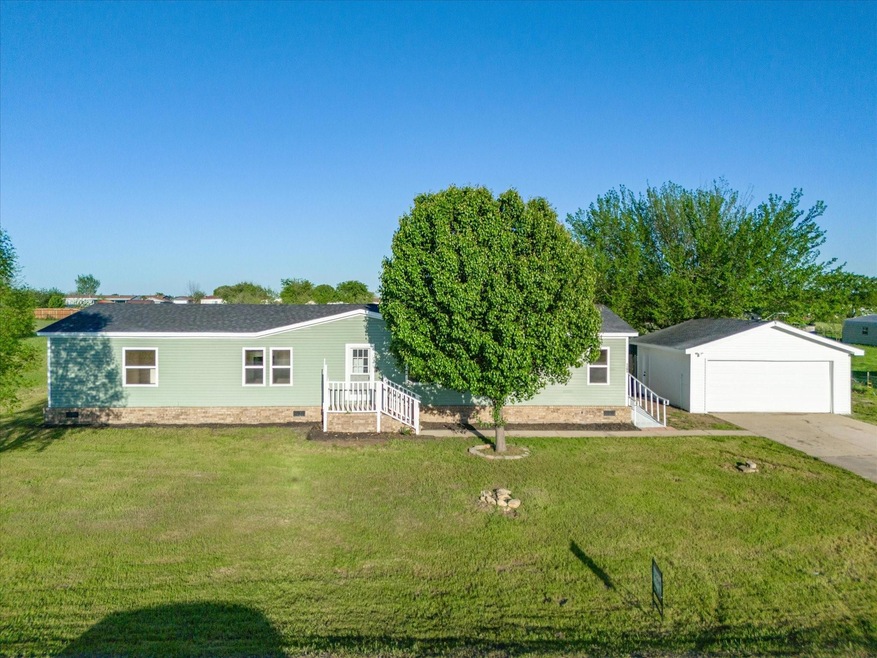 View of front of property with a front lawn and a garage