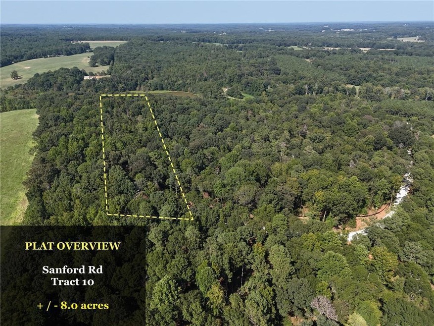 Birds eye view of property with a forest view