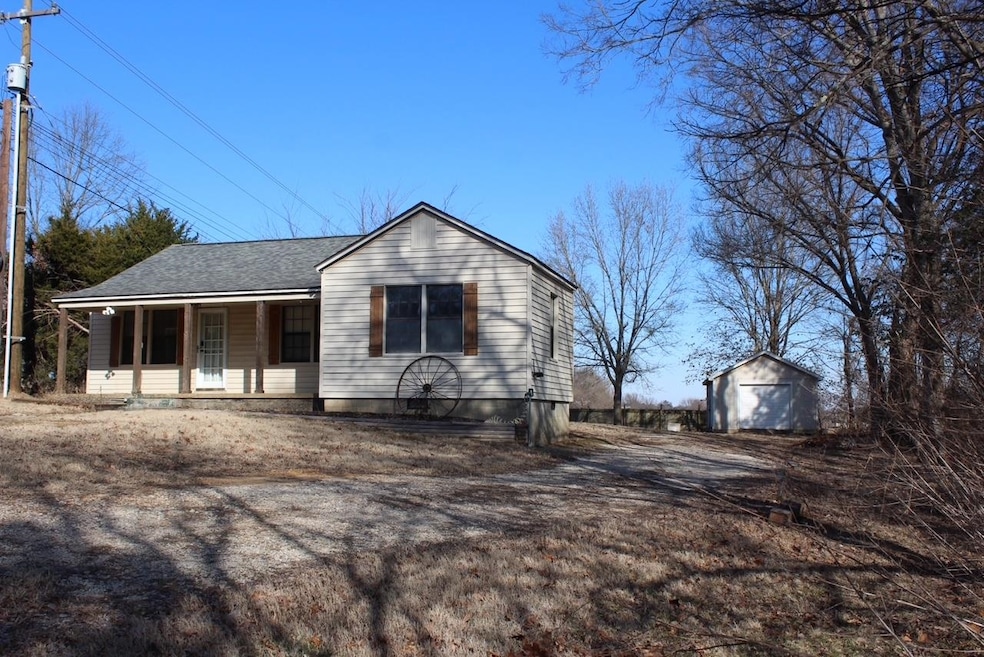Country front porch with detached garage on 1.22 a