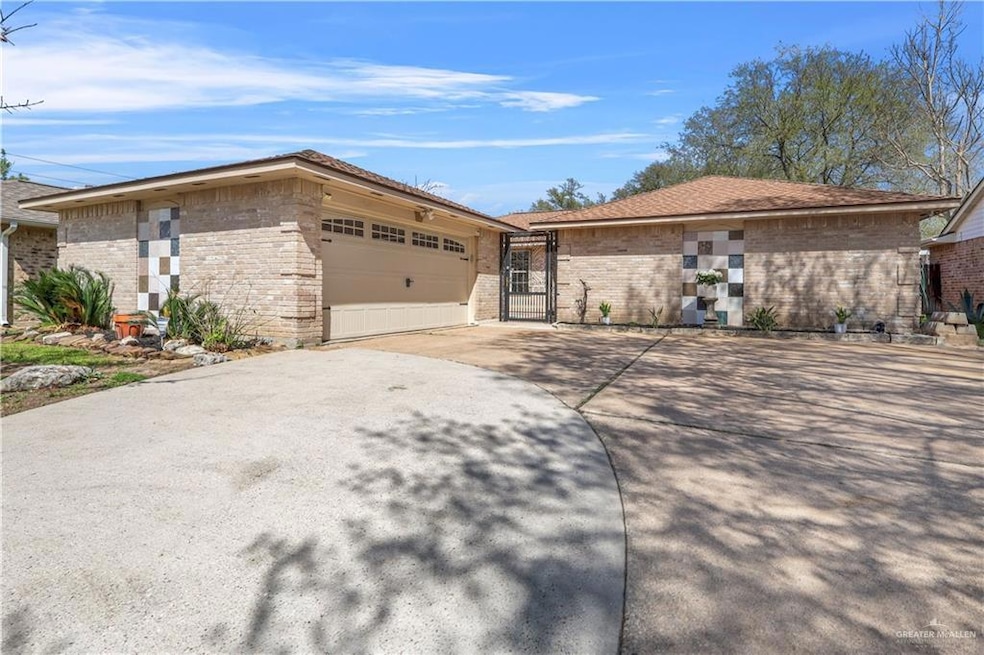 View of front of house with an attached garage, brick siding, and concrete driveway