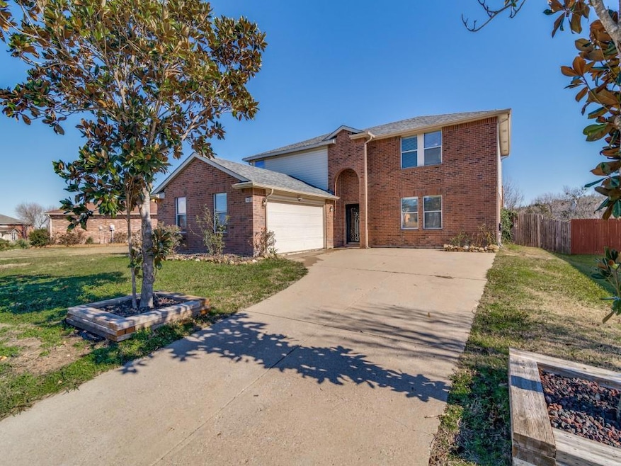 View of front of home with a garage and a front la