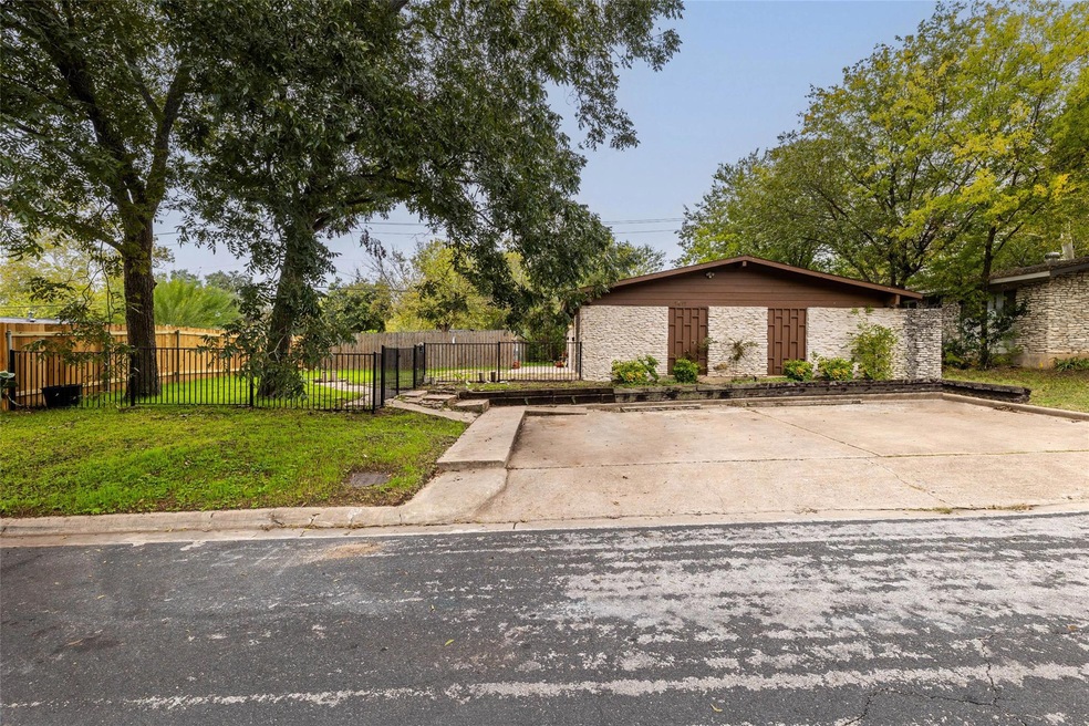 Mid-century home with a front lawn and fence