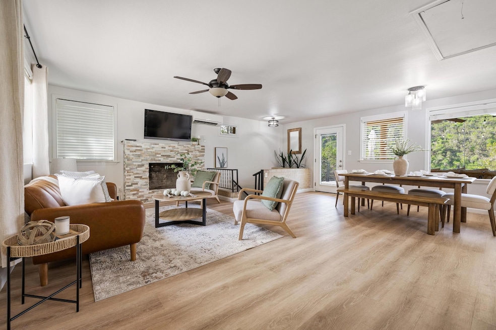 Living area with a ceiling fan, light wood-style 