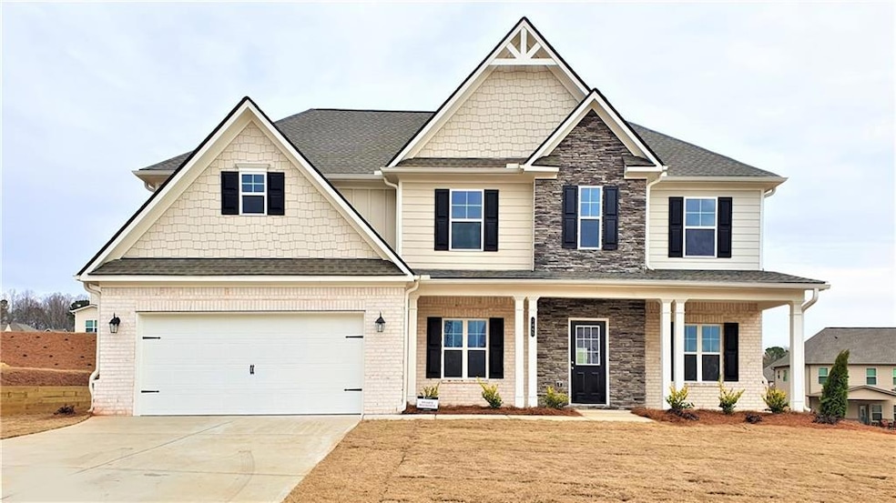 Craftsman house featuring covered porch, stone sid