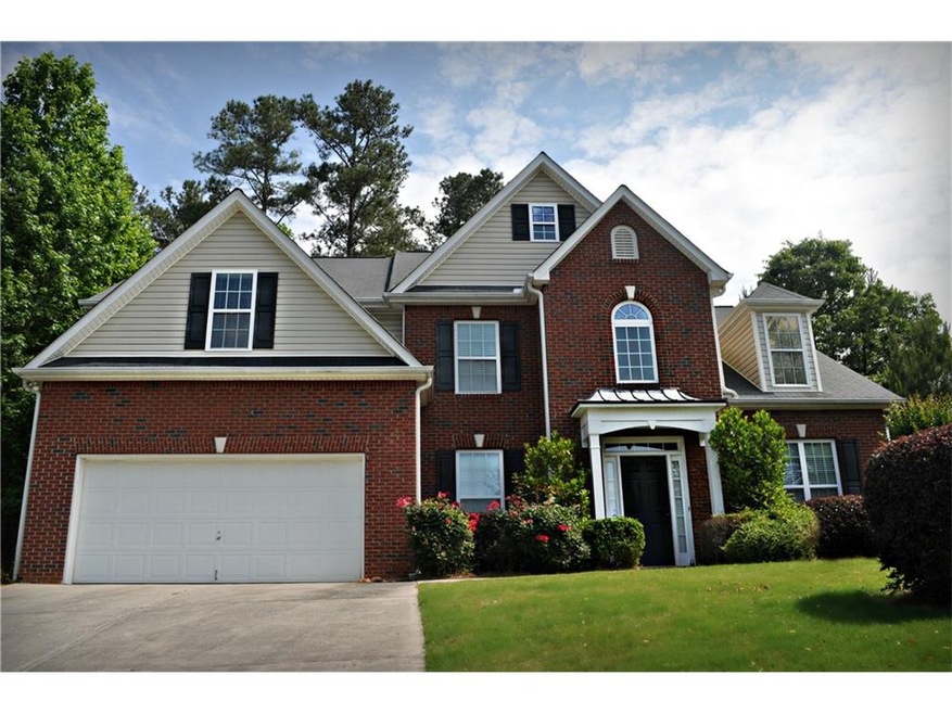 Home sits majestically on a well landscaped elevat