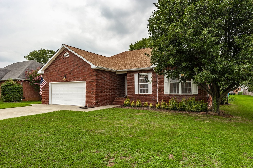 Welcoming entrance with sidewalk from the concrete driveway to a covered front porch with brick steps. Classic architecture with Brick Quoins, Brick mailbox and dimensional shingles. The Ring doorbell stays!