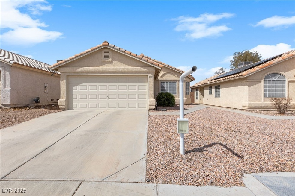 View of front of house featuring a garage, roof mo