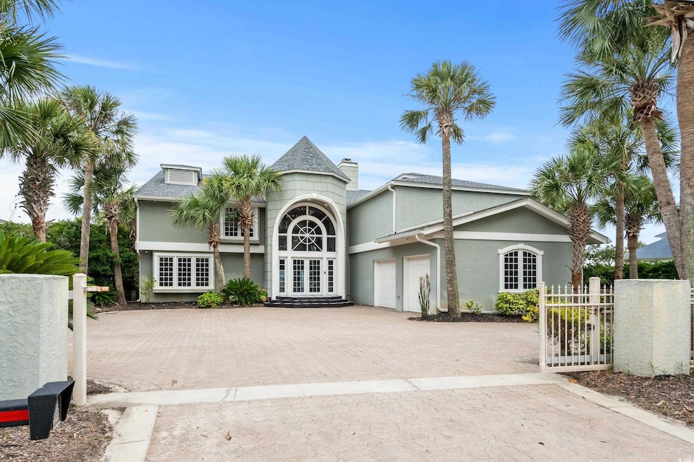 View of front of house with decorative driveway, a