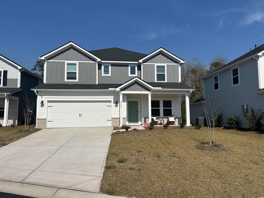 View of front of property featuring a porch, board