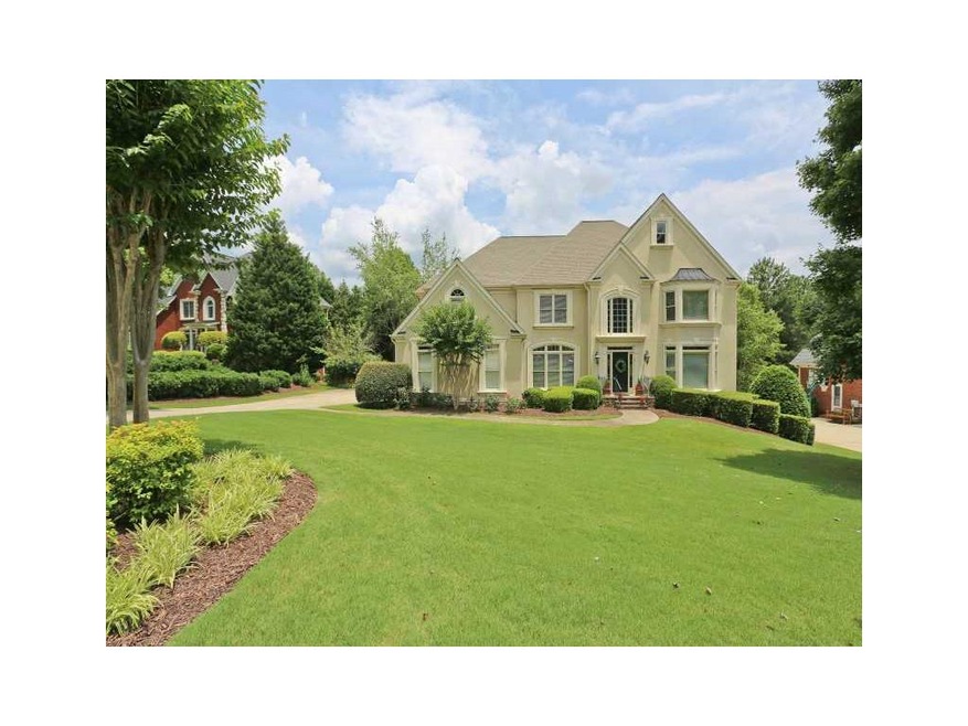 Exterior Front. Elegant hardcoat stucco home on pe