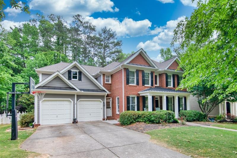 3 car tandem garage and rocking chair front porch