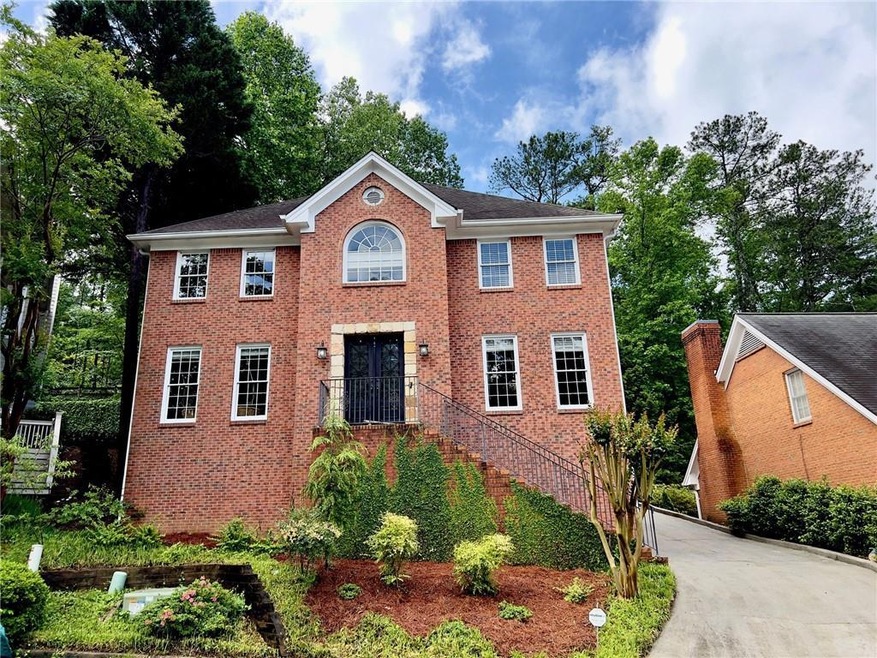 Colonial house with brick siding and concrete driv