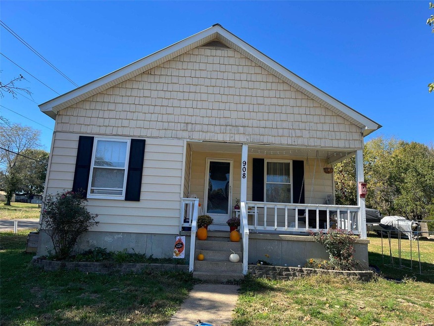 Bungalow-style home with a front lawn and covered porch