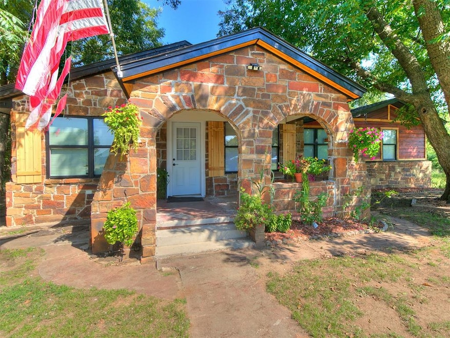 View of front of property with covered porch and stone siding
