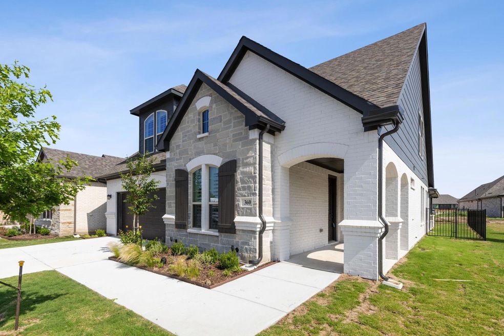 French country inspired facade with a front yard