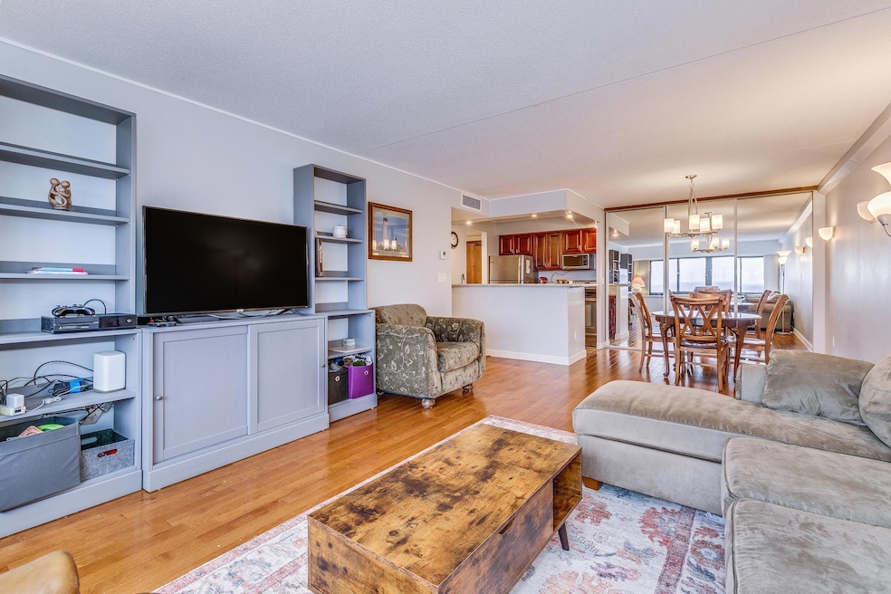 Living Room looking towards Kitchen with Stainless Steel Appliances and Informal Dinning Room