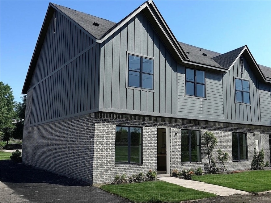 View of front facade with board and batten siding,