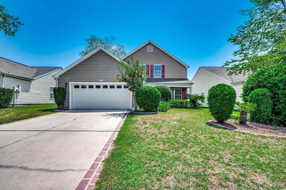 View of front property with a garage and a front l