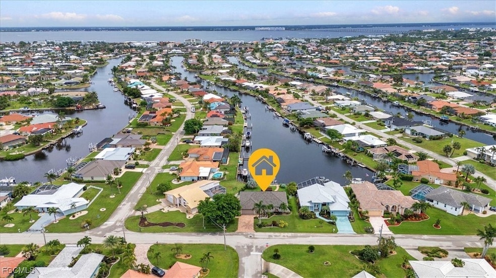 Aerial view of property's waterfront  location with a nearby body of water and nearby suburban area