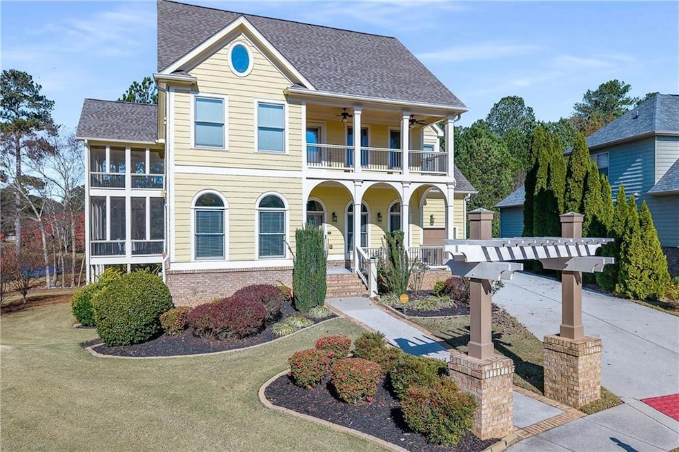 View of front of house with a porch, brick siding, and roof with shingles