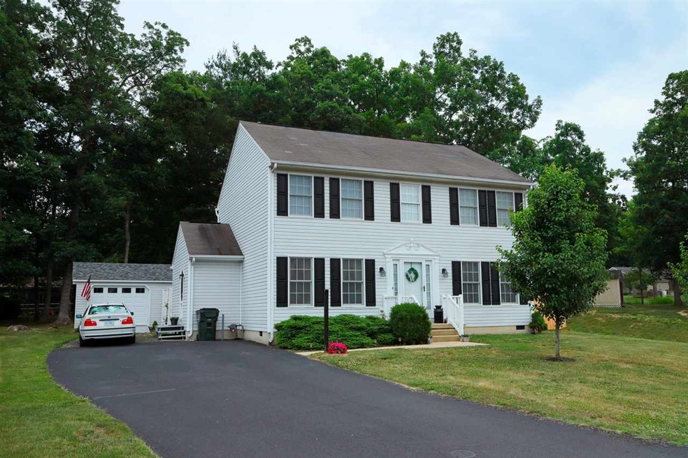 with mature trees in the backyard.