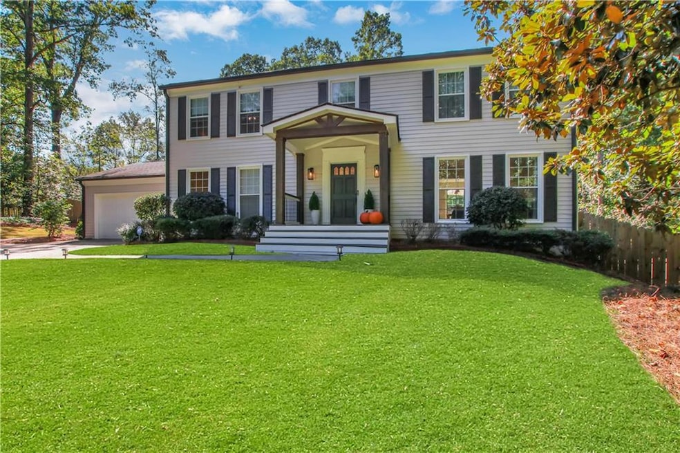 Colonial inspired home with covered porch, concrete driveway, and a garage