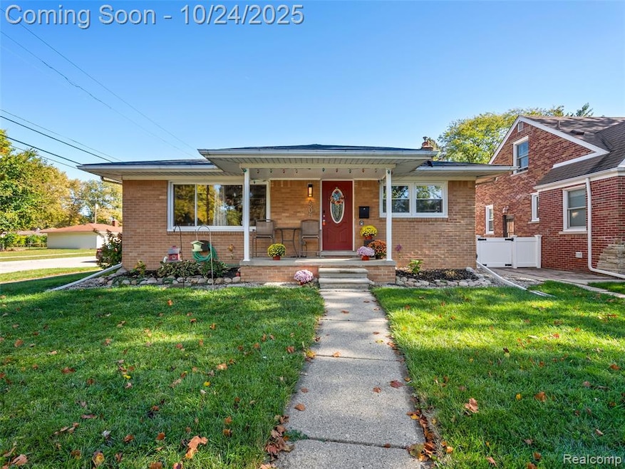 Bungalow featuring a porch, a front yard, brick siding, and a chimney