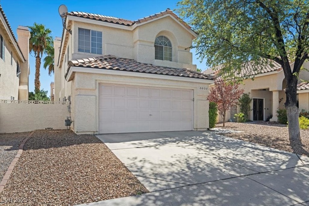 Mediterranean / spanish house with a tiled roof, concrete driveway, stucco siding, and an attached garage