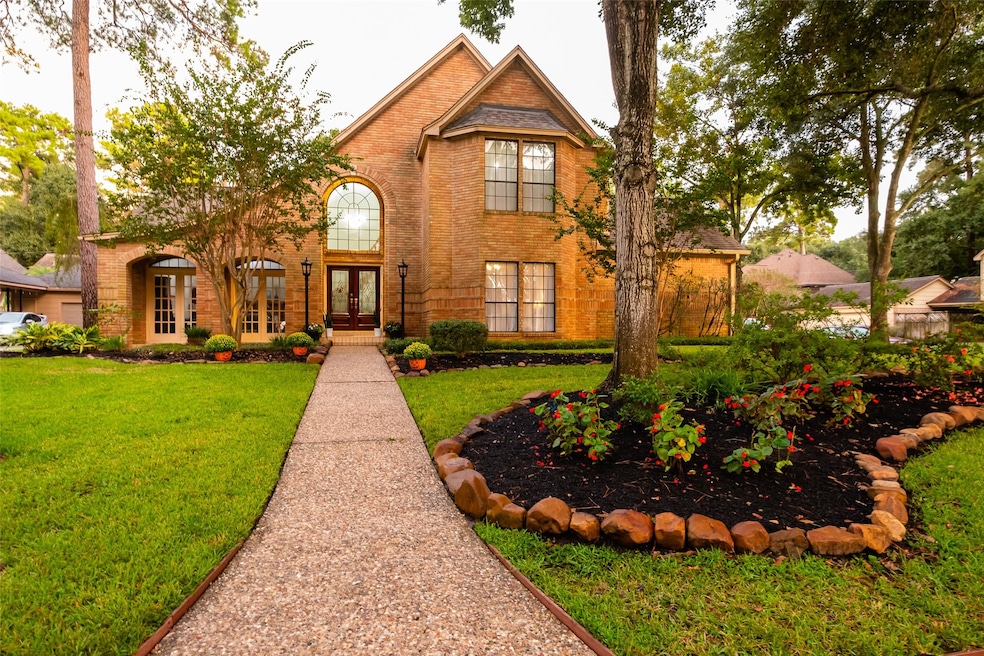 Welcome home! Beautiful corner lot with mature trees and lush landscaping