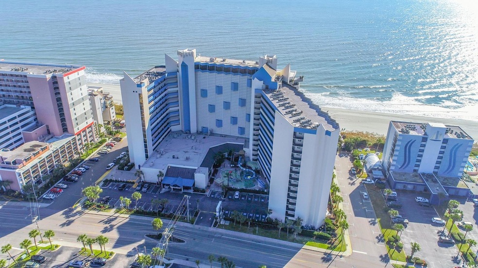 Bird's eye view with a view of the beach and a wat
