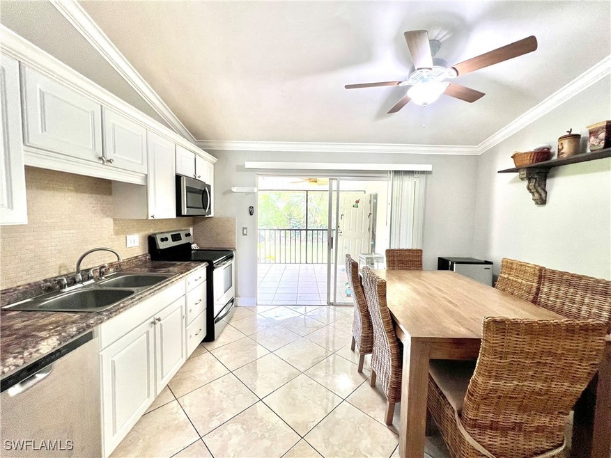 Kitchen with ceiling fan, ornamental molding, whit