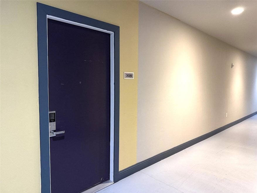 Corridor with baseboards and recessed lighting