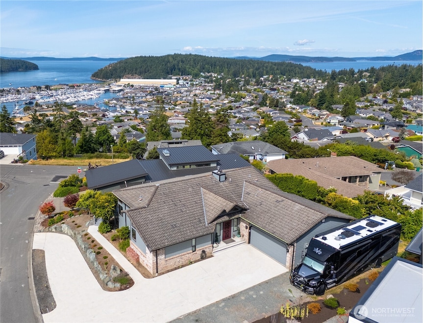 Incredible one story home with basement overlooking Burrows Bay. Look at all that off street parking and that huge space to park RV and/or boat!!! (For scale, that RV is 45' long)