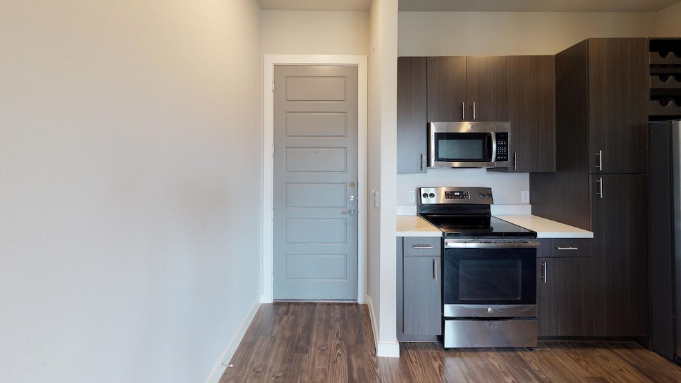 Kitchen with dark brown cabinets, stainless steel 