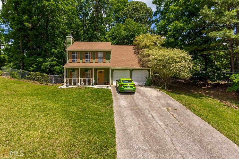 View of the large front yard and rocking chair fro