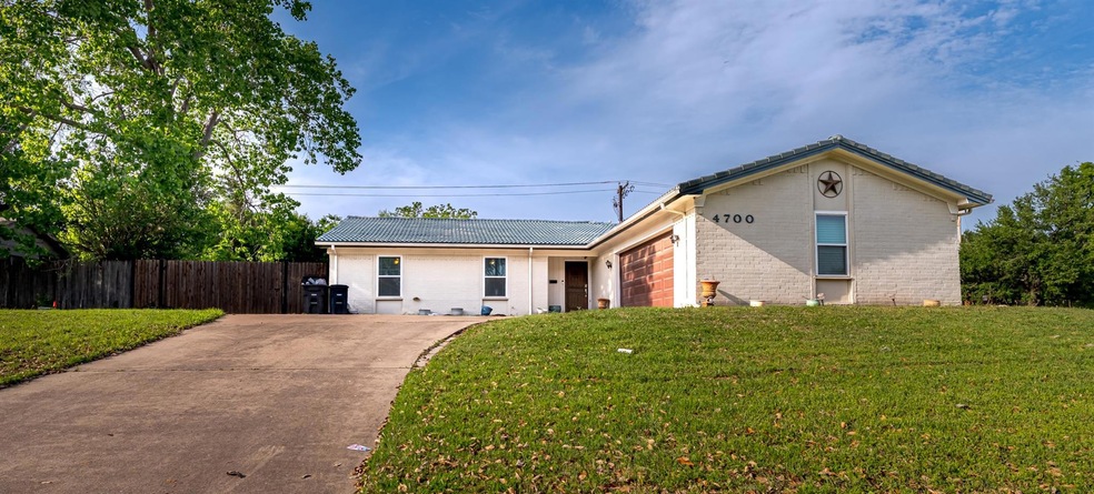 Single story home featuring a front yard, a garage