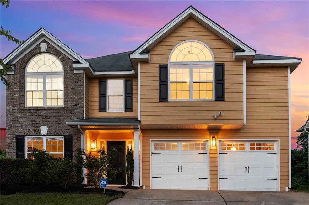 View of front of home with a garage and driveway