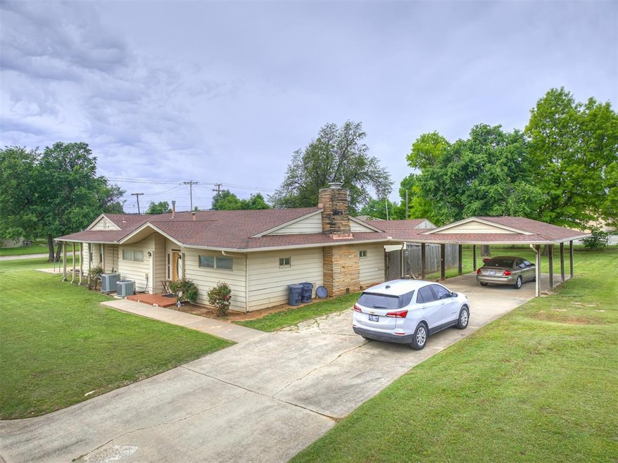 View of front facade with a front lawn, roof with shingles, a patio, and cooling unit