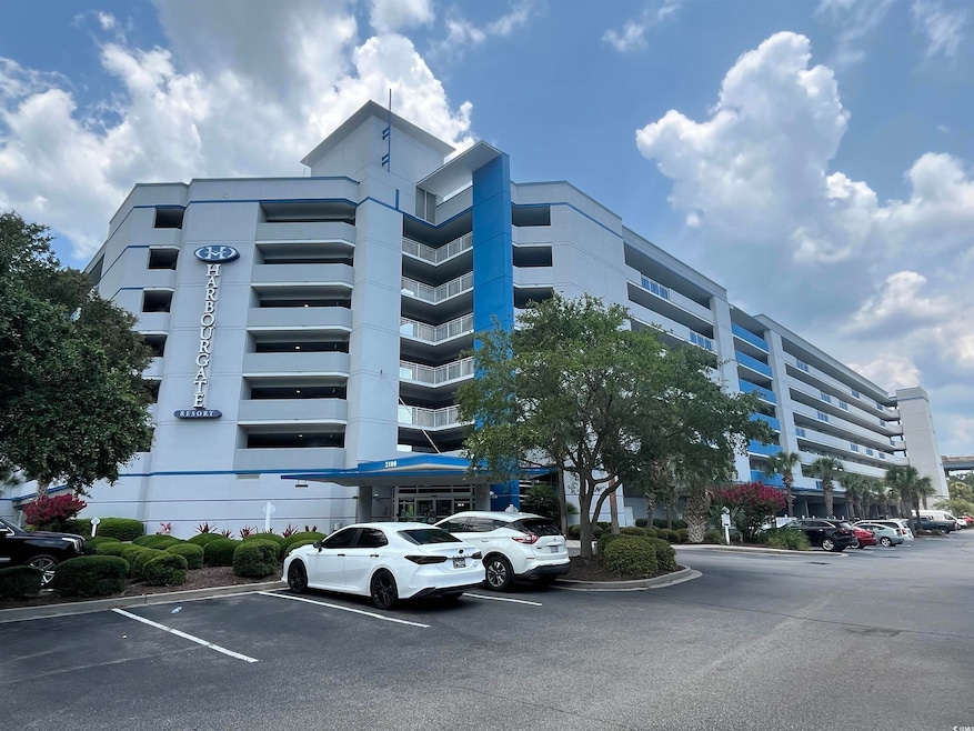 View of building exterior with uncovered parking
