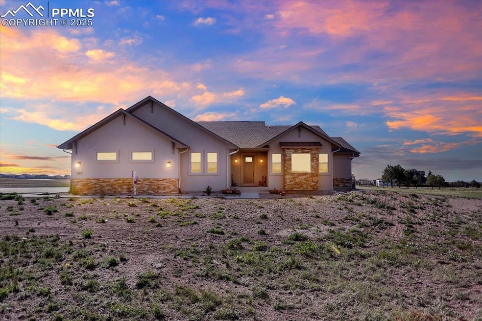 View of front of property featuring stone siding and stucco siding