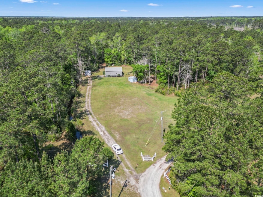 Birds eye view of property with a wooded view