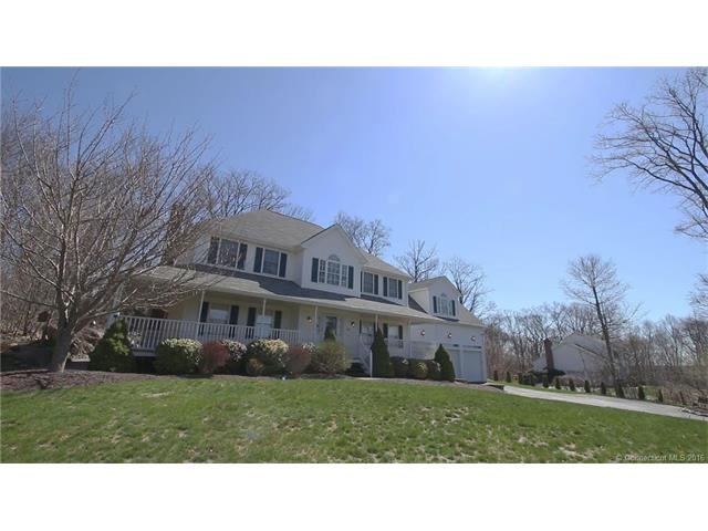 Stately Colonial with wraparound front porch sitti