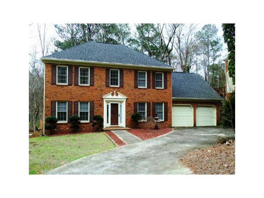 Exterior Front. 3 sides brick with unfinished base
