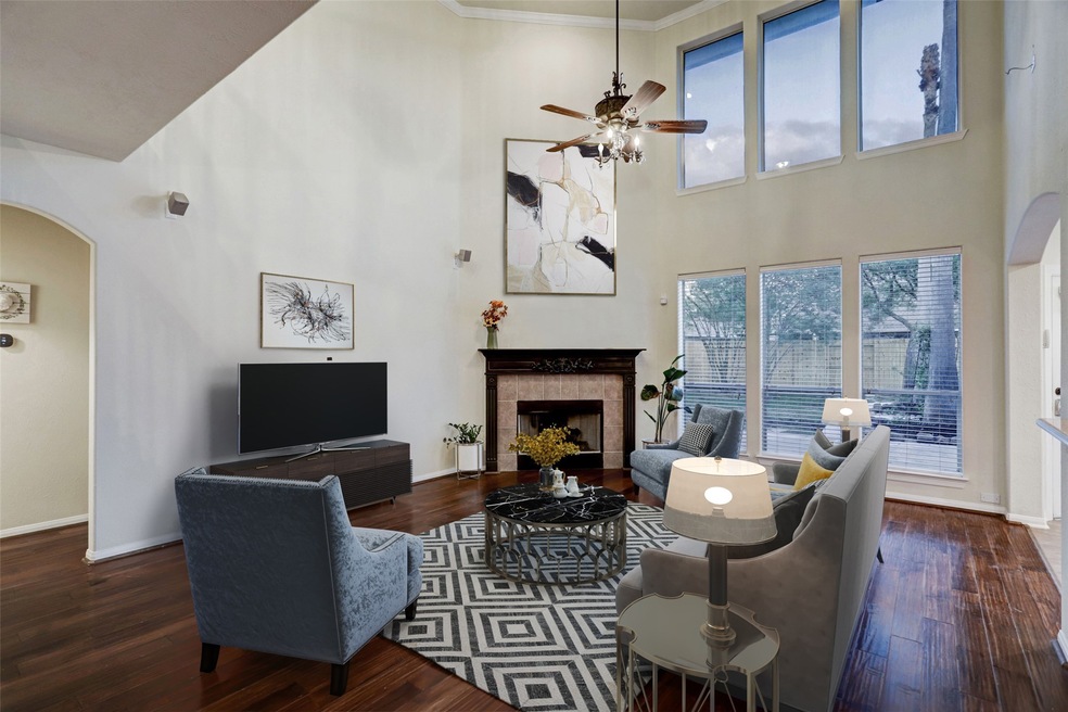 Living room featuring tall ceilings with large windows allowing for an abundance of natural light.