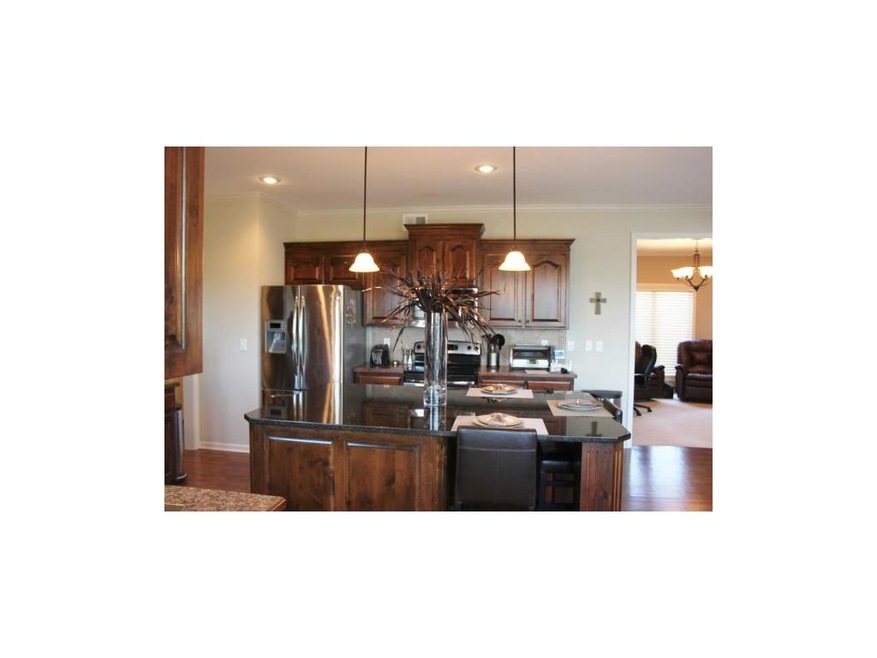 Alder Kitchen Cabinets with large granite island a