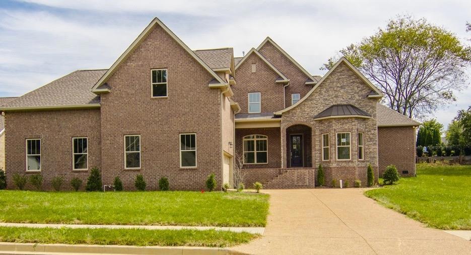 Spacious rocking chair front porch with lovely stone work.  
