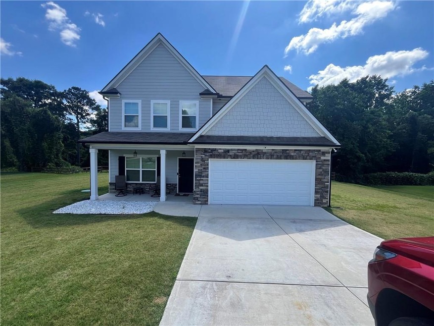 View of front facade with a garage, a front yard, 
