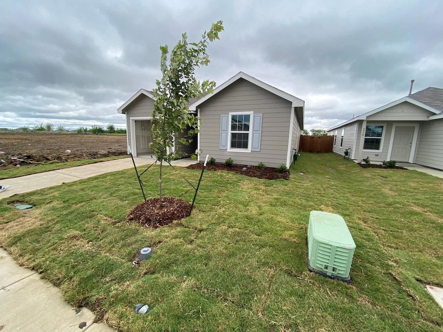 View of front facade with an attached garage, driv
