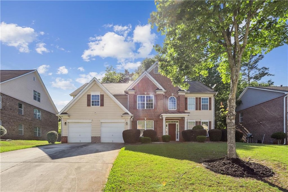 View of front of house featuring brick siding, dri